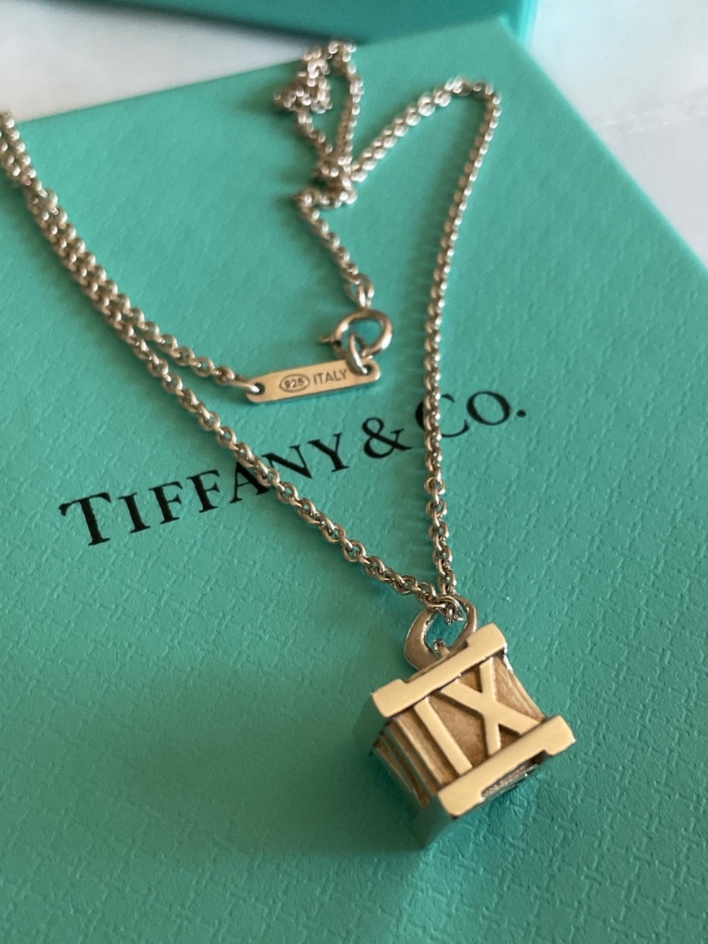 Tiffany & Co. Sterling Silver Roman Numeral Cube Necklace on Blue